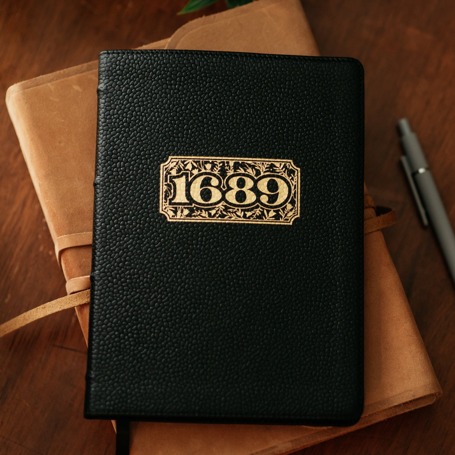Black leather 1689 on a wooden surface