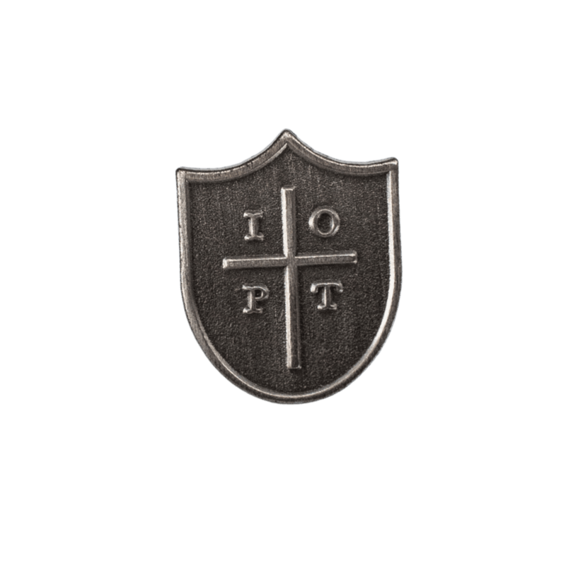 A small shield-shaped metallic emblem with a cross dividing four letters, shown centered on a solid green background.