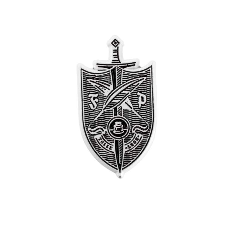 A shield-shaped silver metal pin featuring a black engraved design of a sword, feathers inkwell, and the text 'F.P.