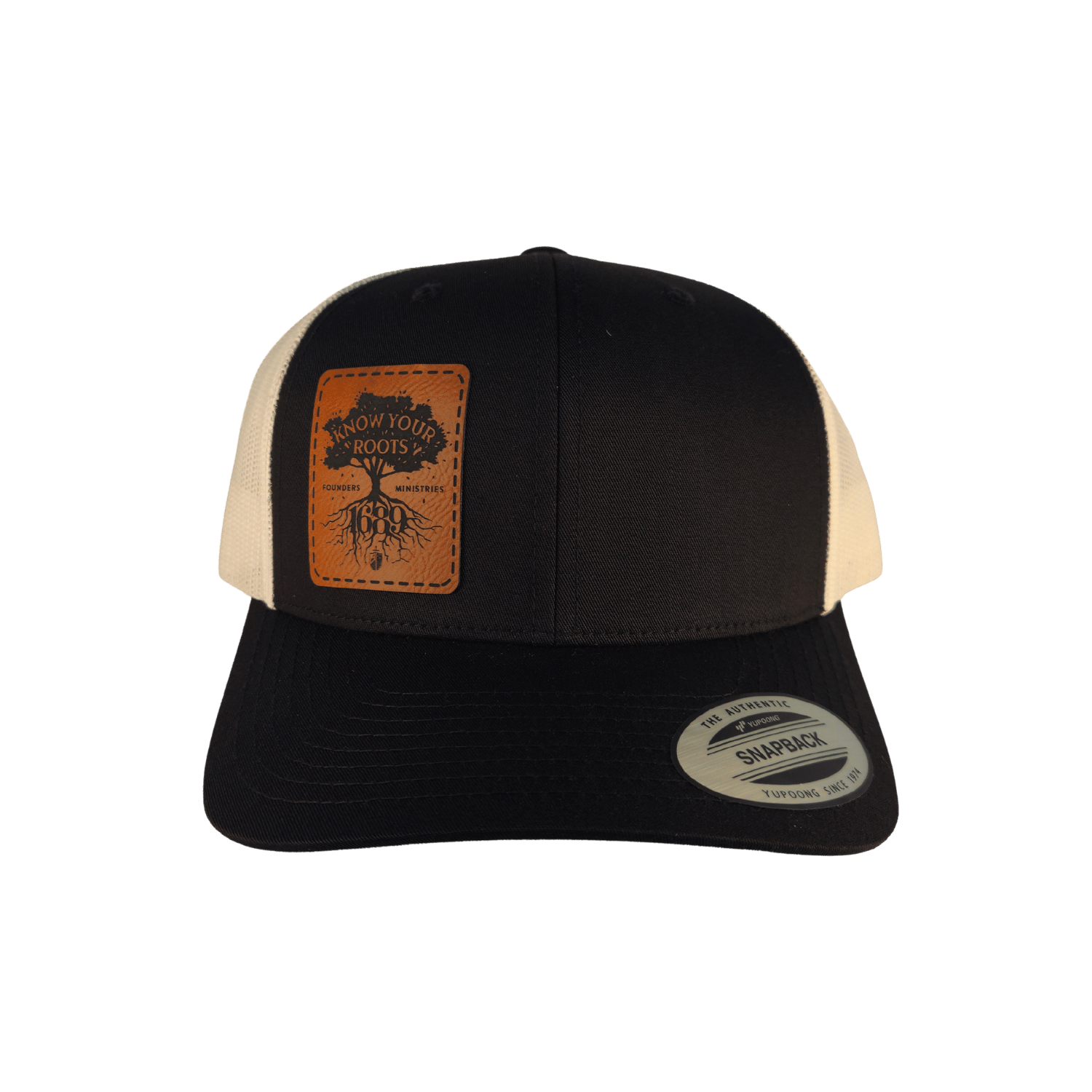 A black trucker hat with a brown leather patch on the front displaying 'Know Your Roots 1689' and a tree graphic.
