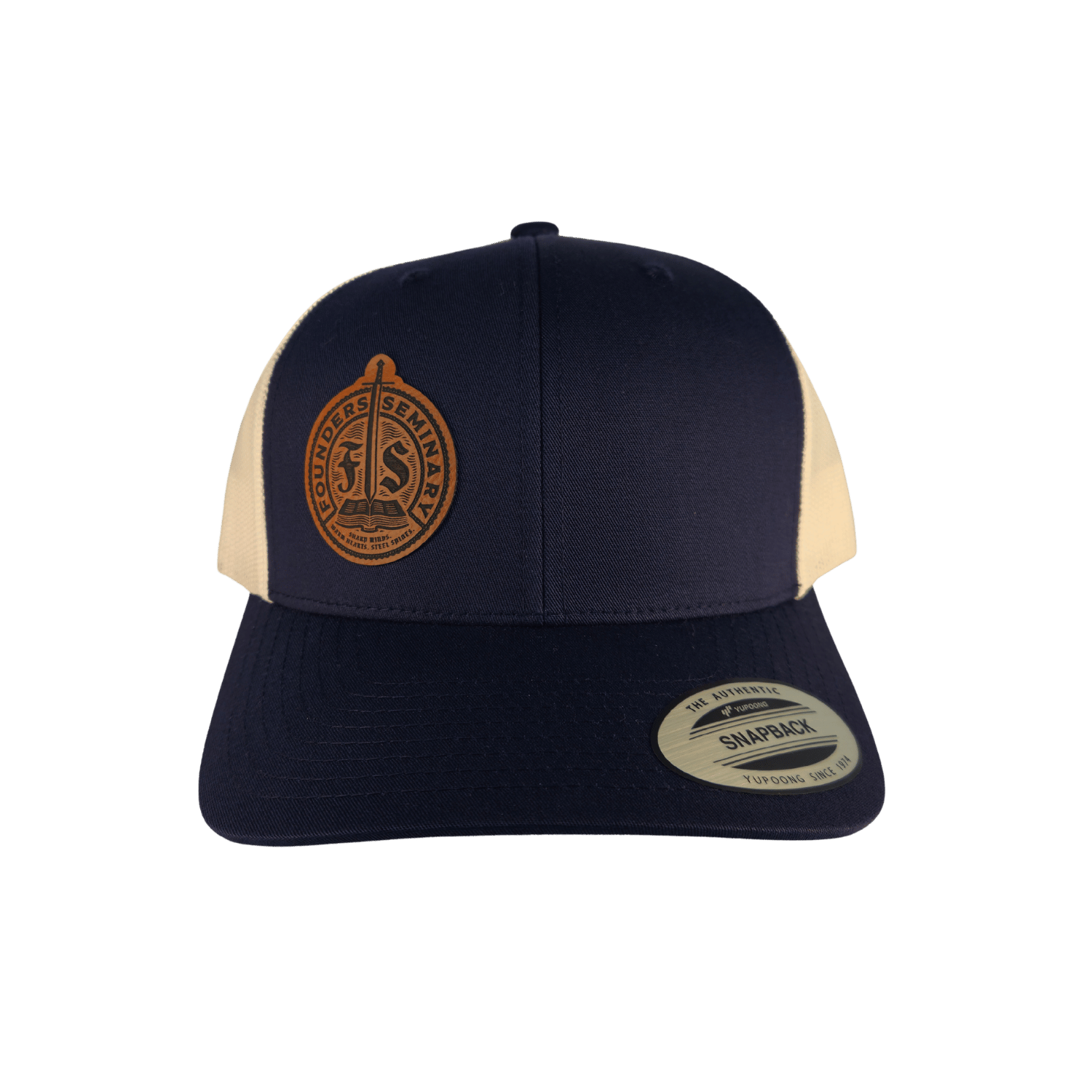 A navy blue and cream trucker hat with a circular brown embroidered patch on the front and a visible Snapback brand sticker on the brim, set against a solid green background.