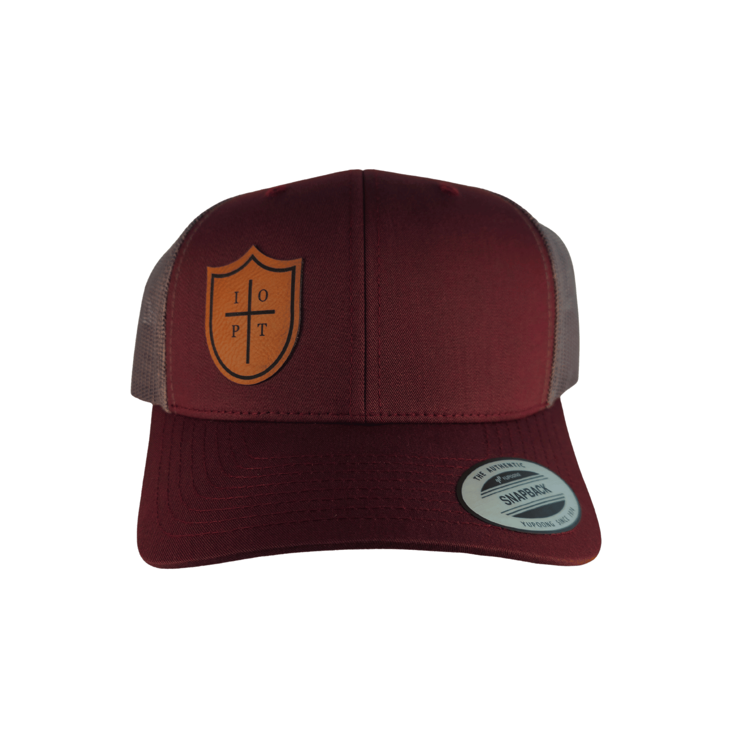 A maroon trucker hat with a tan shield logo on the front panel.