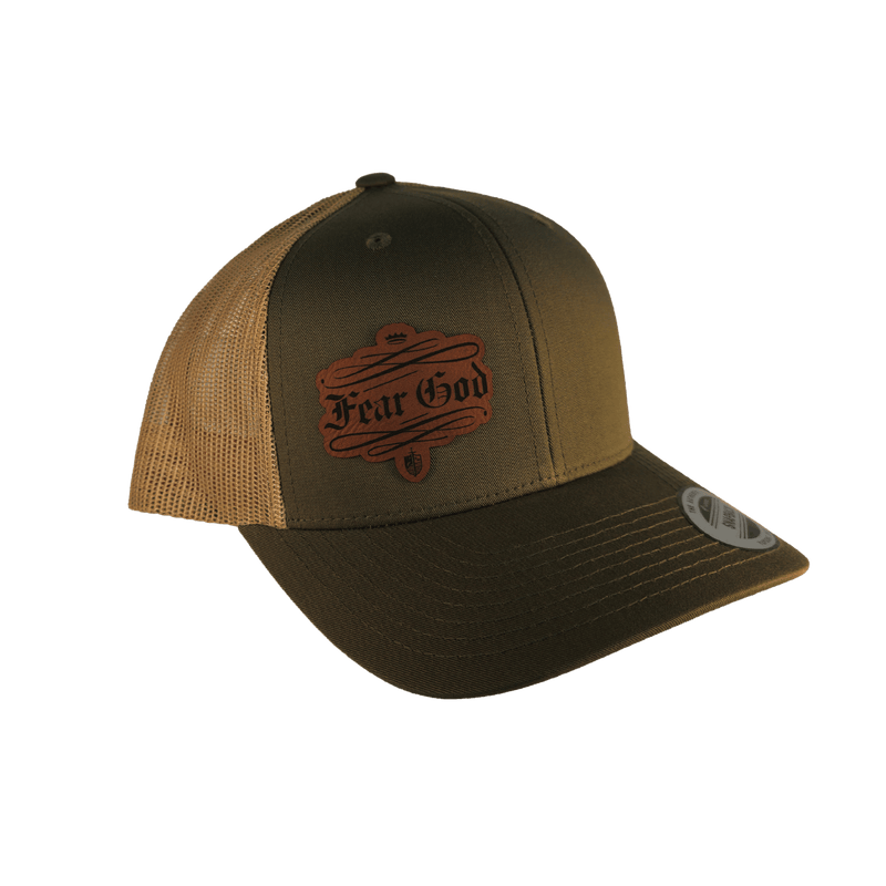 A trucker-style baseball cap with an olive green front panel and brim, tan mesh side panels, and a brown embroidered 'Fear God' patch on the front.