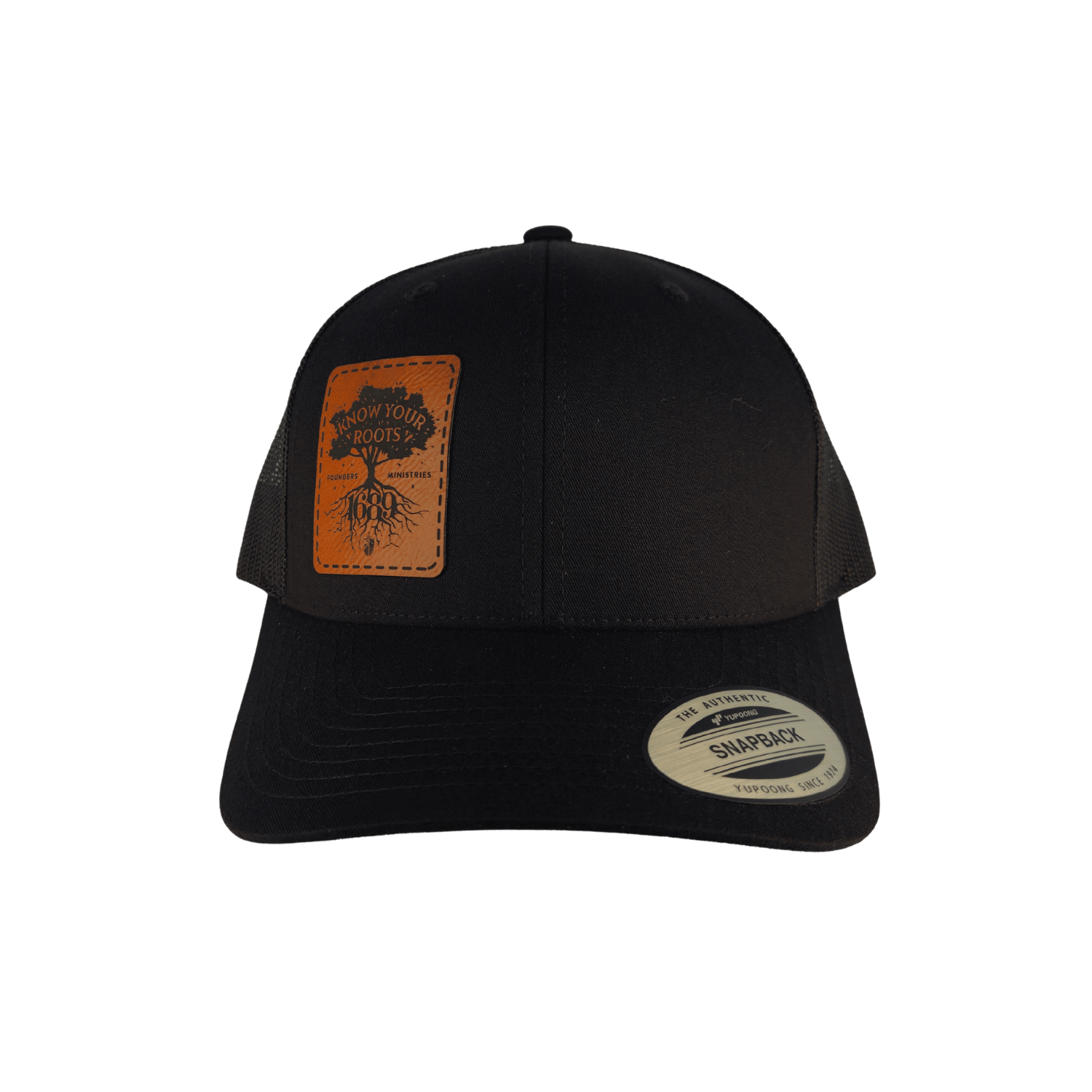 A black trucker hat with a brown leather patch on the front displaying 'Know Your Roots 1689' and a tree graphic.