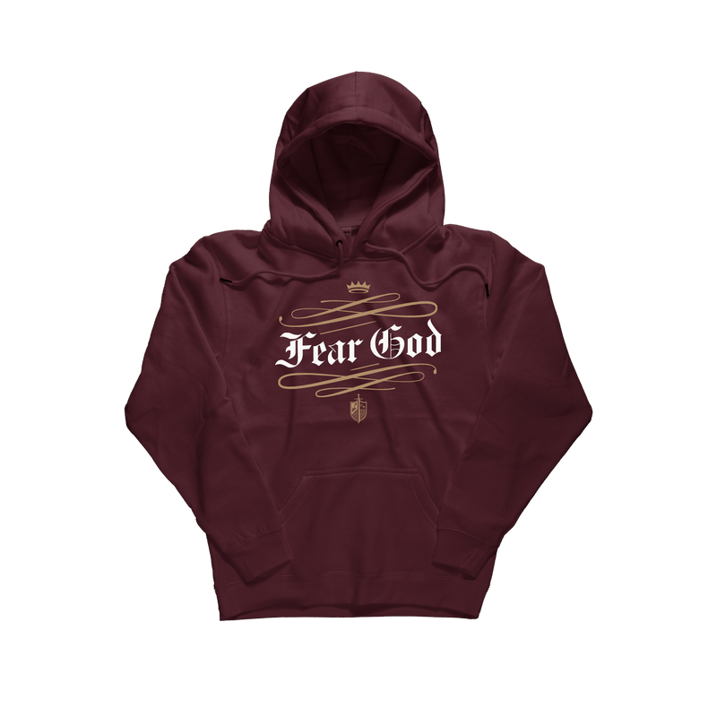 A maroon pullover hoodie with a front graphic that reads 'Fear God' in white gothic lettering, decorated with gold-colored scrollwork, a small crown, and a crest emblem. The hoodie is displayed flat against a solid white background. [Maroon]