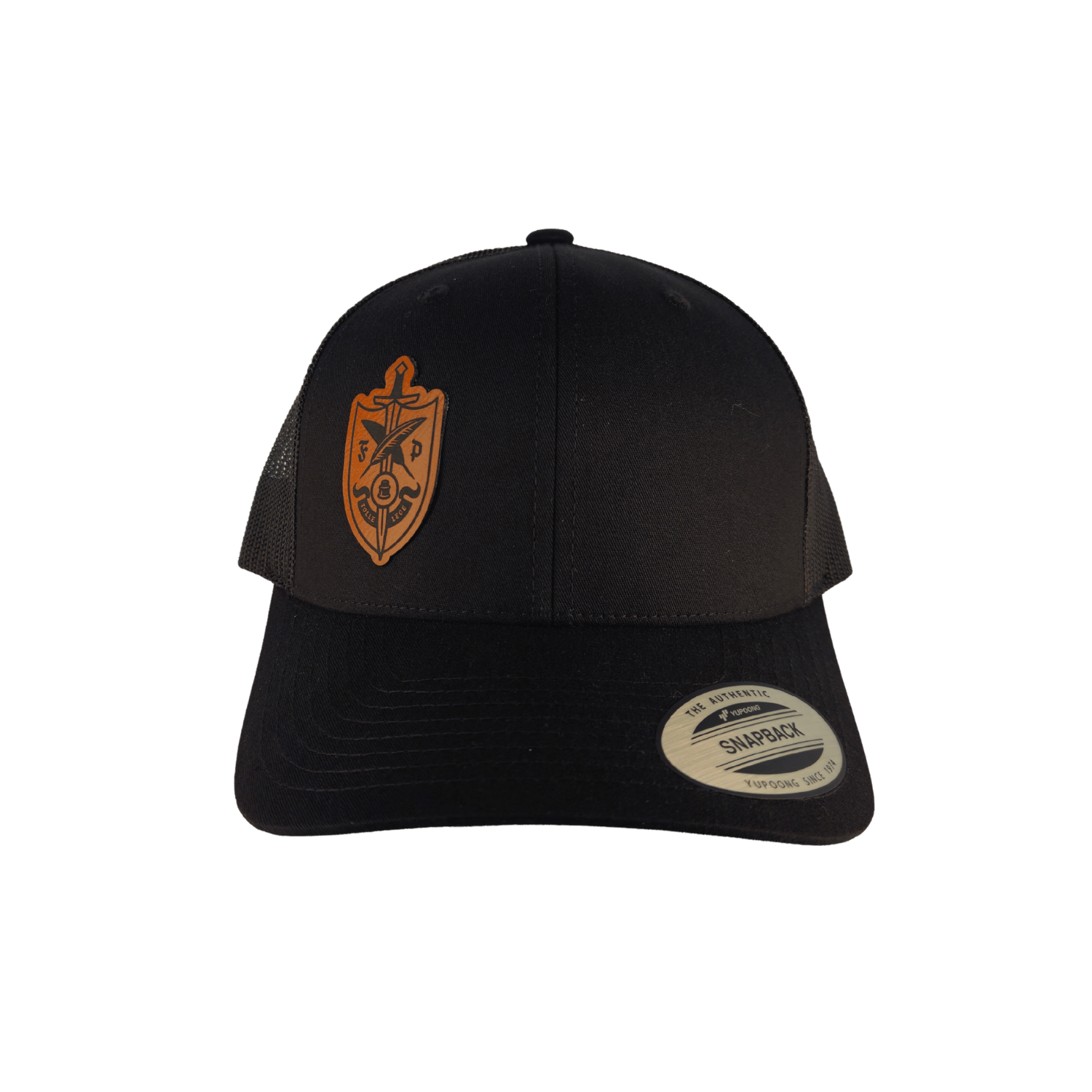 A black trucker-style cap with a tan shield-shaped embroidered crest on the front panel 