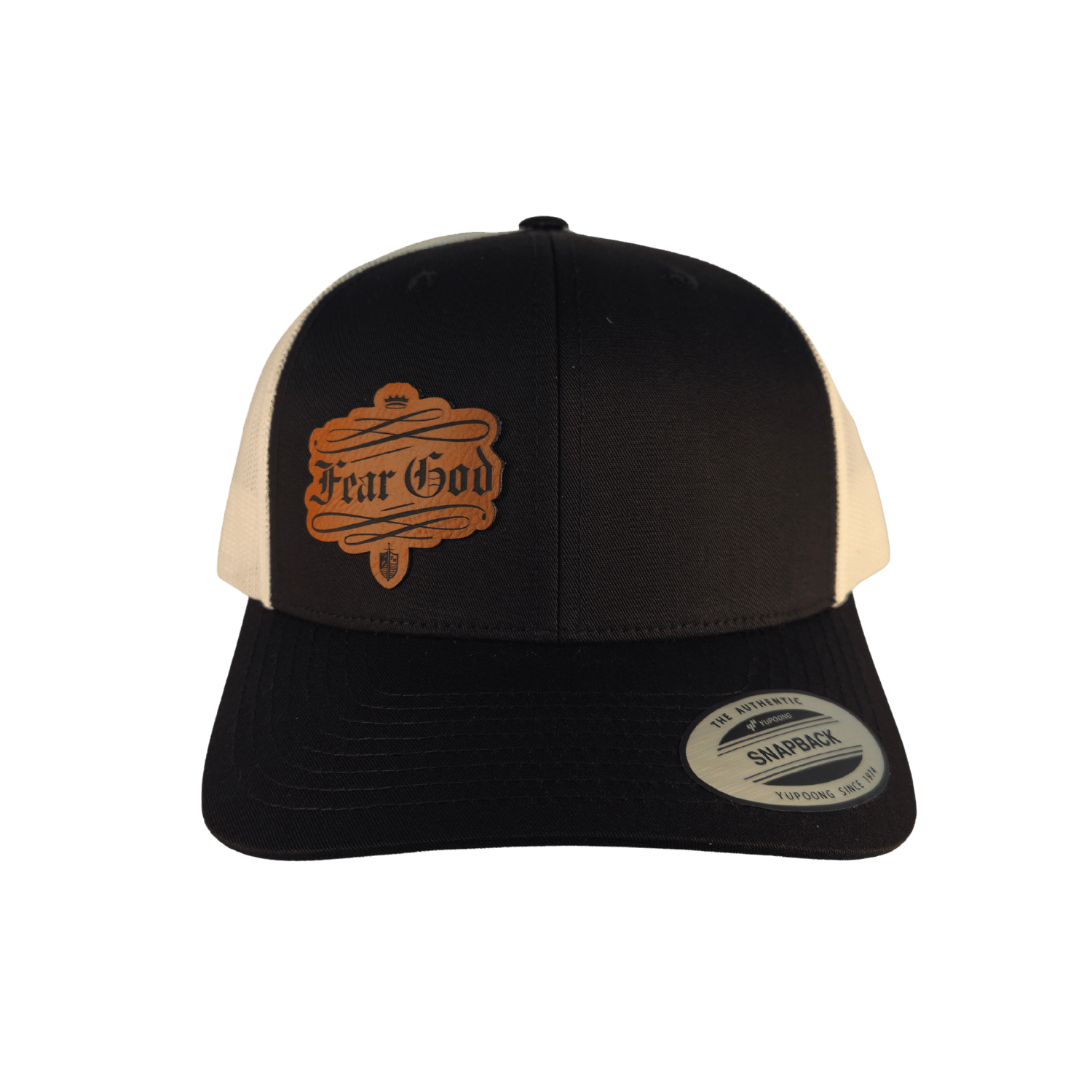 A black and cream trucker hat with a brown embroidered 'Fear God' patch on the front. The cap features a black front panel and brim, with cream mesh back panels. (Black)