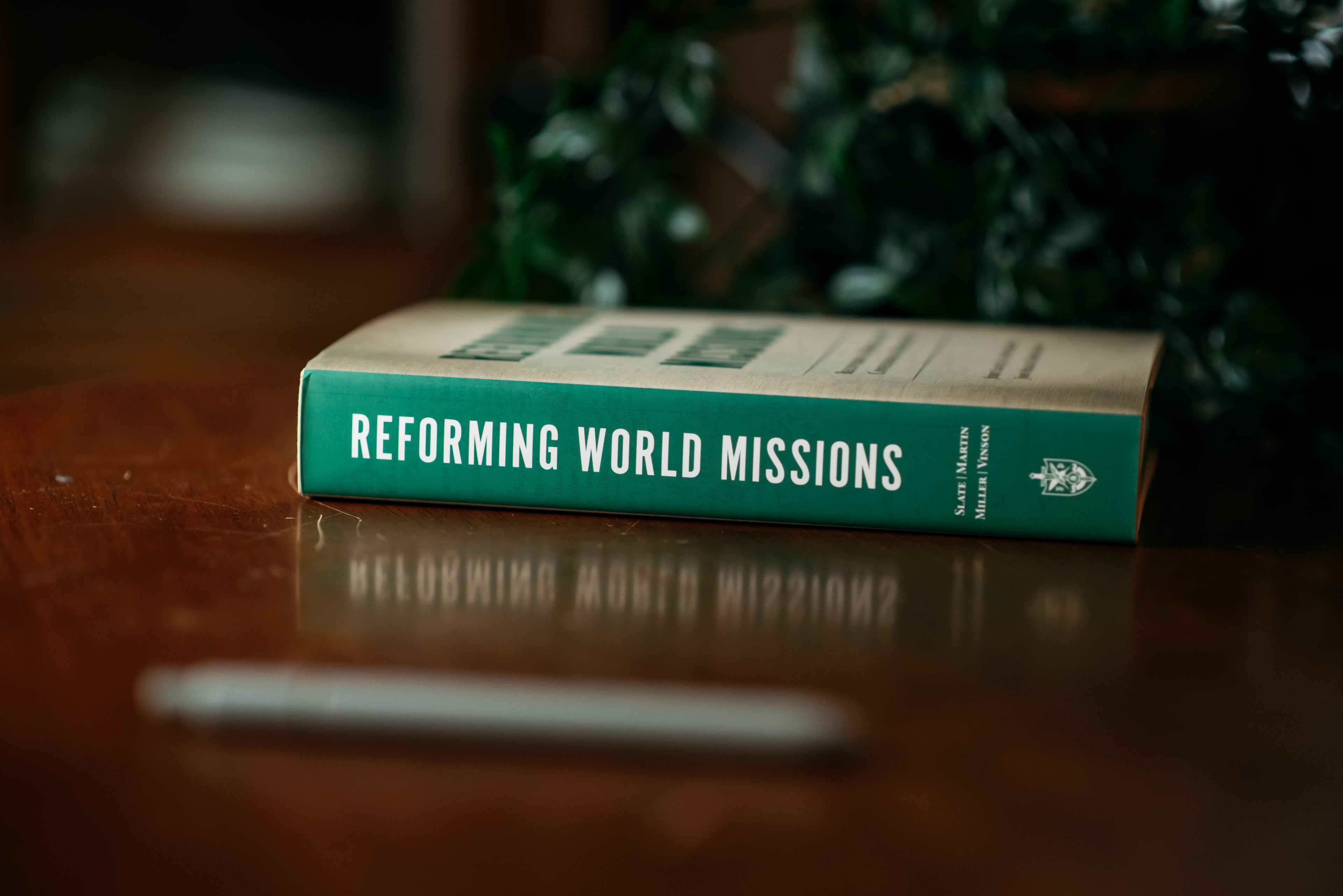 Picture of the spine of 'Reforming World Missions' on a wood background
