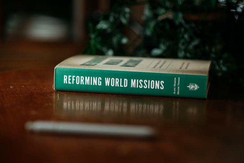 Picture of the spine of 'Reforming World Missions' on a wood background