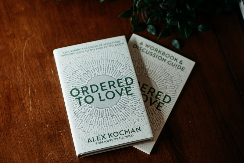 Ordered to Love book and workbook on wood table
