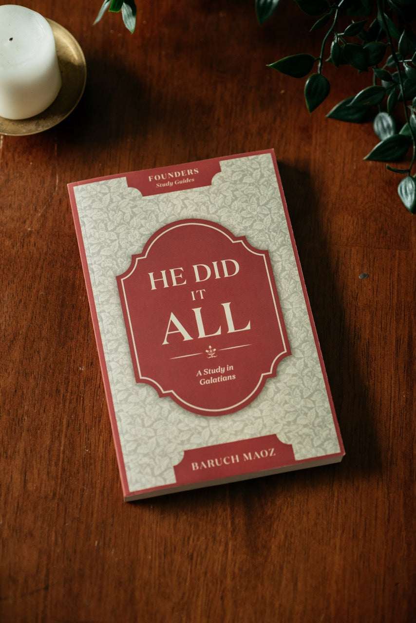 He Did It All Book on wood table with plant and candle. 