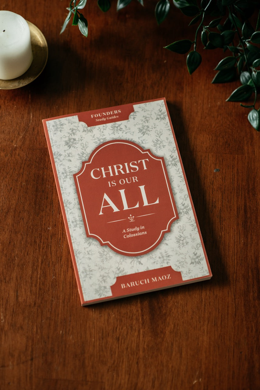 Christ is Our All Book on wood table with plant and candle. 