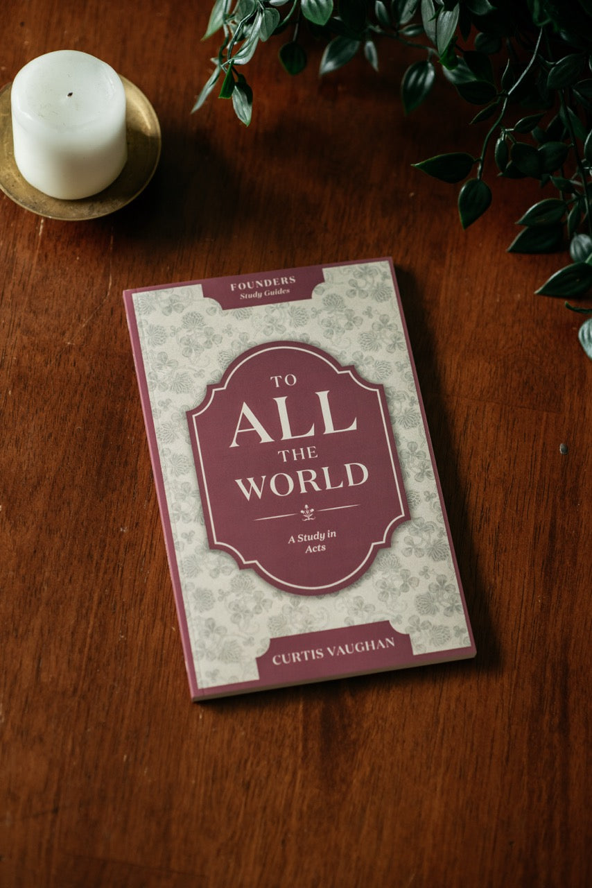 To All the World Book on wood table with plant and candle. 