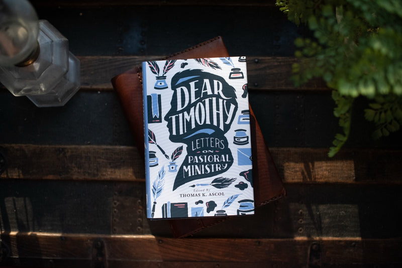 Dear Timothy book on wood table with plant and decorative elements. 