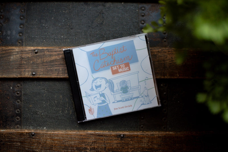 Baptist Catechism CD on a wood table