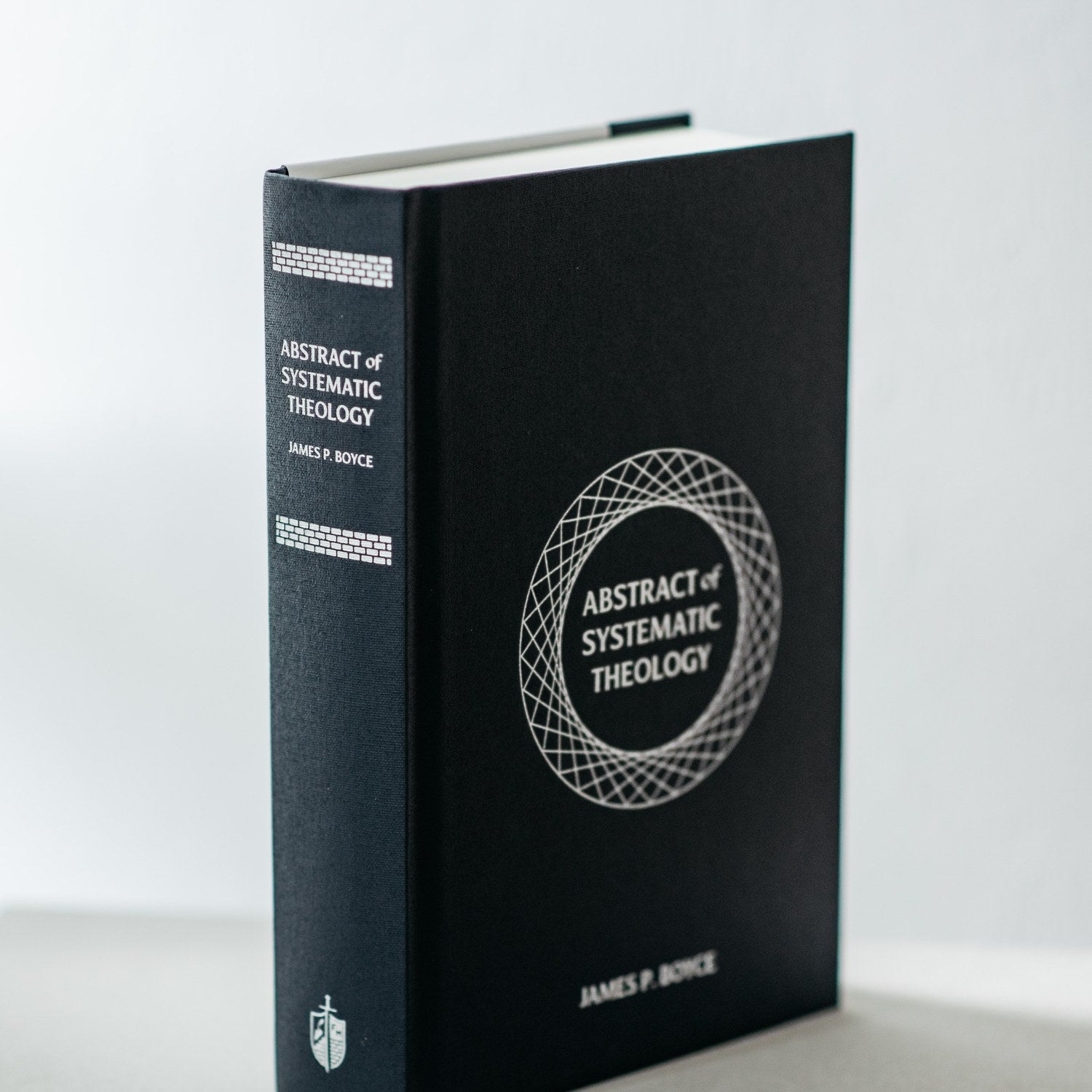 Book titled 'Abstract of Systematic Theology' on a white background