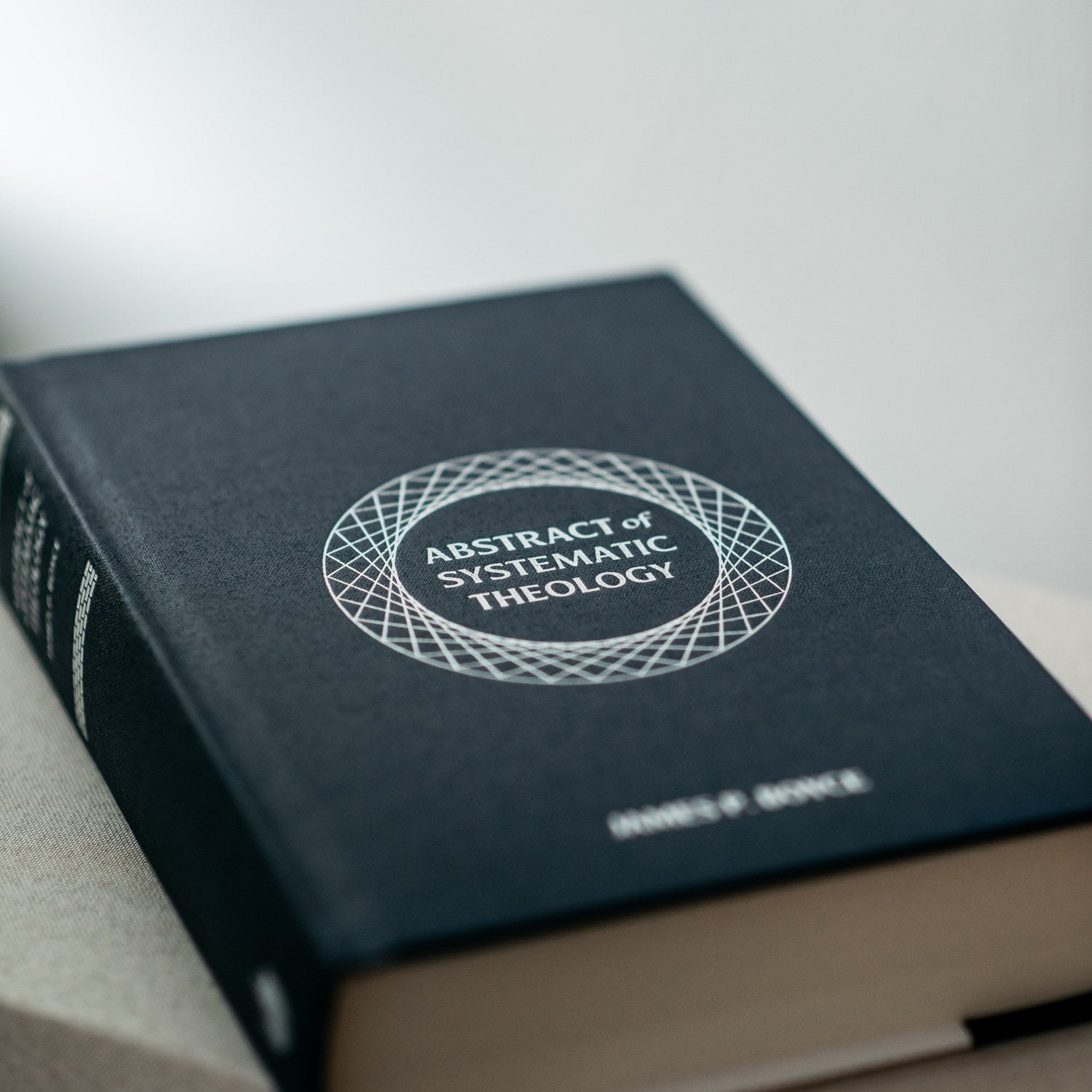 Book titled 'Abstract of Systematic Theology' on a light background