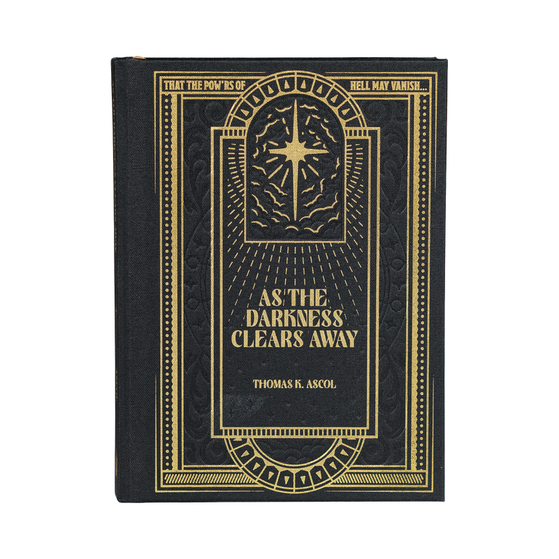 Book titled 'As the Darkness Clears Away' with gold text on a black background