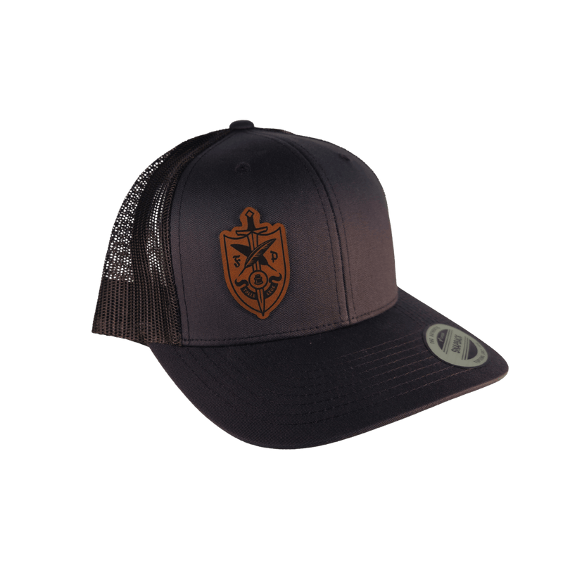 A dark charcoal trucker cap with a brown embroidered shield and sword logo on the front [Smoke]
