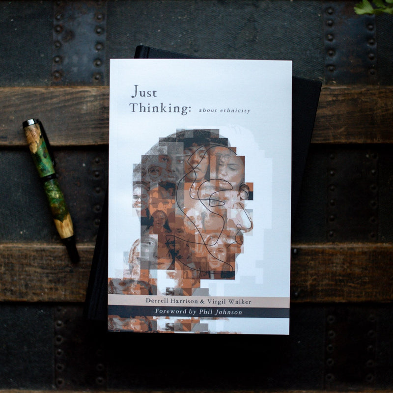 Book titled 'Just Thinking' on a textured surface with a pen beside it
