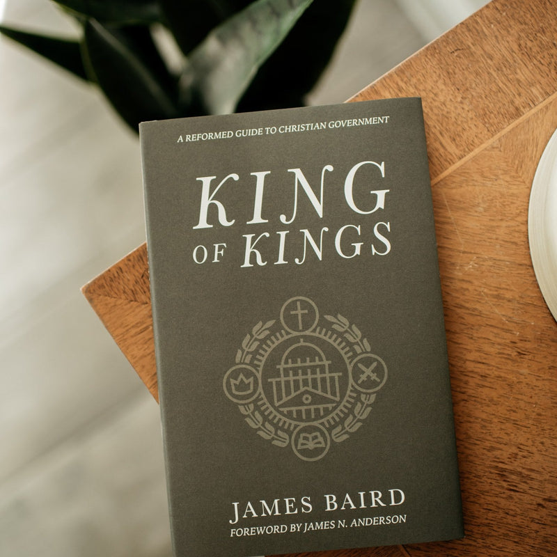 Book titled 'King of Kings' by James Baird on a wooden surface with a blurred background