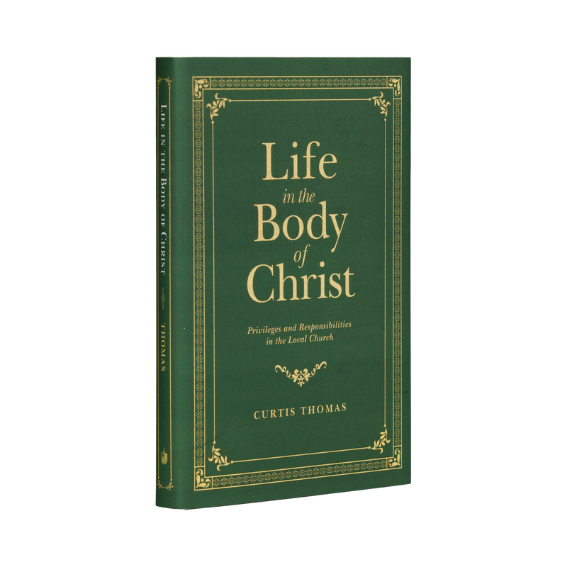 Book titled 'Life in the Body of Christ' by Curtis Thomas with a green cover and gold text on a white background.