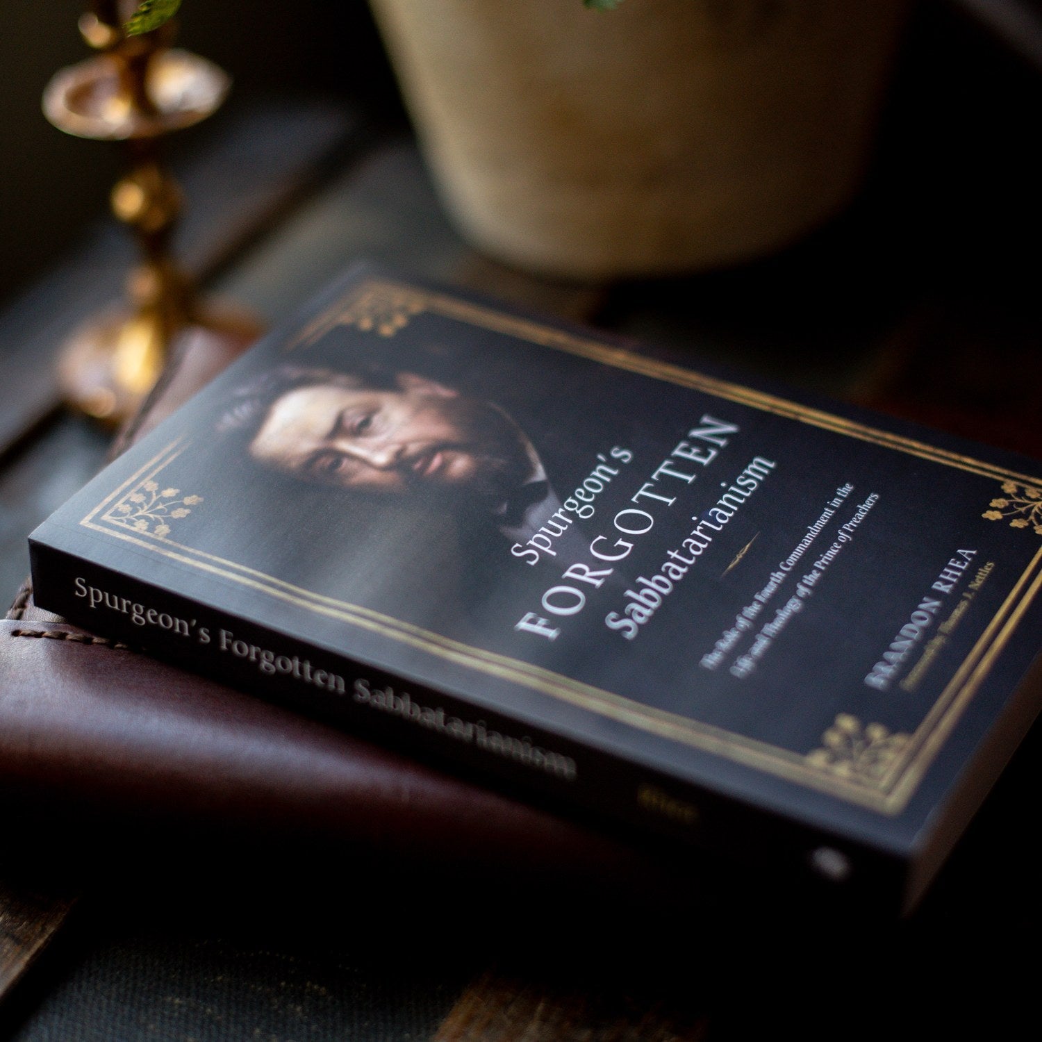 Book titled 'Spurgeon's Forgotten Sabbaarianism' on a wooden surface with a blurred background