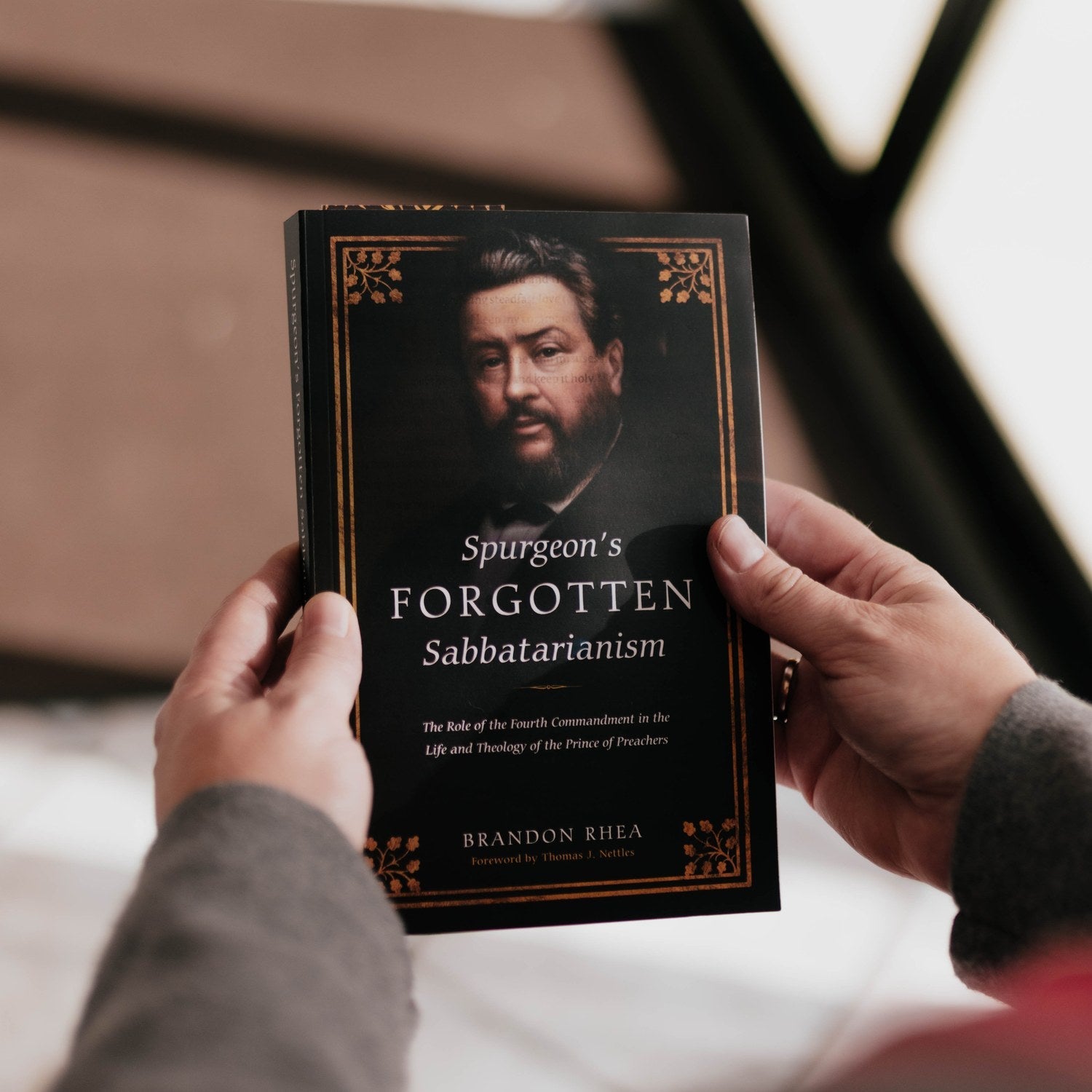 Book titled 'Spurgeon's Forgotten Sabatarianism' held by a person