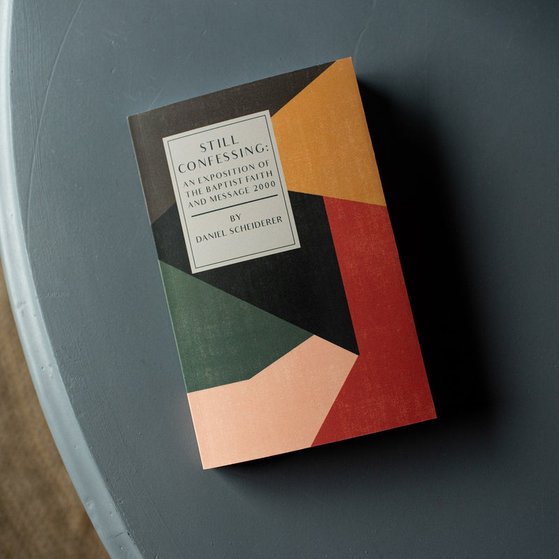 Book with geometric cover design on a dark surface