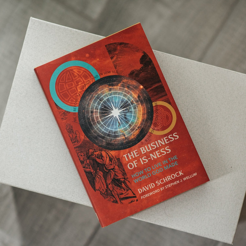 Book titled 'The Business of Is-ness' on a textured surface