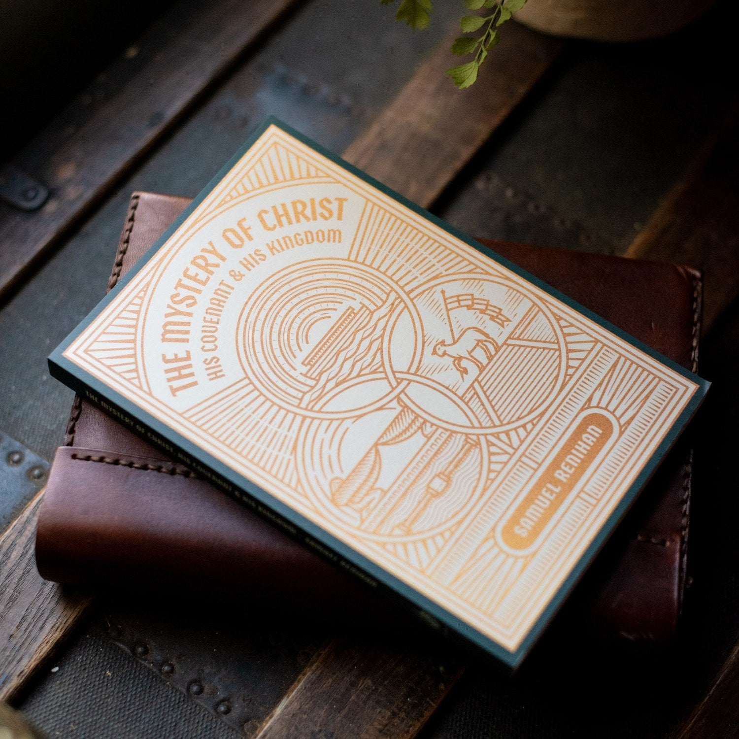 Book titled 'The Mystery of Christ' on a wooden surface