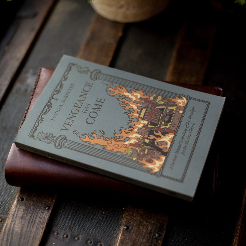 Book titled 'Vengeance Has Come' on a wooden surface